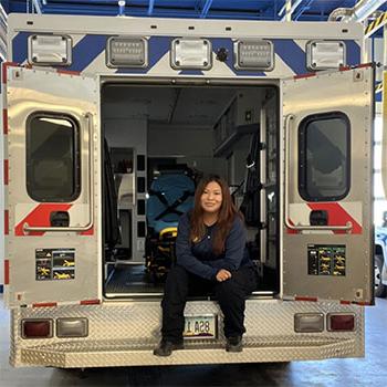 Tashawnee Wood sits in the back of an ambulance.